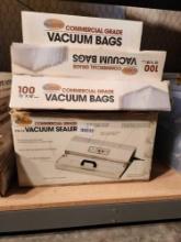 Cabela's commercial grade vacuum sealer, used and three boxes of vacuum bags, new.