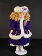 16" Porcelain doll in a purple velvet dress w/ matching coat & hat