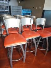 Metal bar chair with orange cushion seat