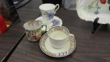 tea cups and saucers, two from england and one asian