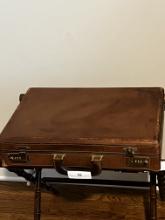 Empty Vintage Leather Briefcase. One side is unlocked.