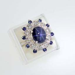 APP: 25.1k 14 kt. White Gold, 6CT Oval Cabochon Cut Star Sapphire and 0.42CT Diamond Ring