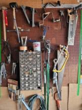 Assorted tools and miscellaneous on wall.