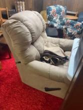 Brown fabric recliner chair in basement