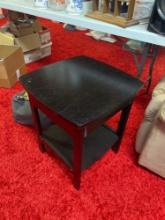 Black colored end table in basement