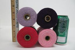 20 spools of Mayville carpet warp, purple, pinks and reds, 4" tall