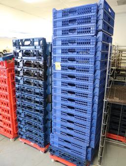 stacks of bakery trays on carts