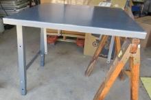 36" x 36" heavy duty steel work tables.  These tables come with legs on one side and are designed to