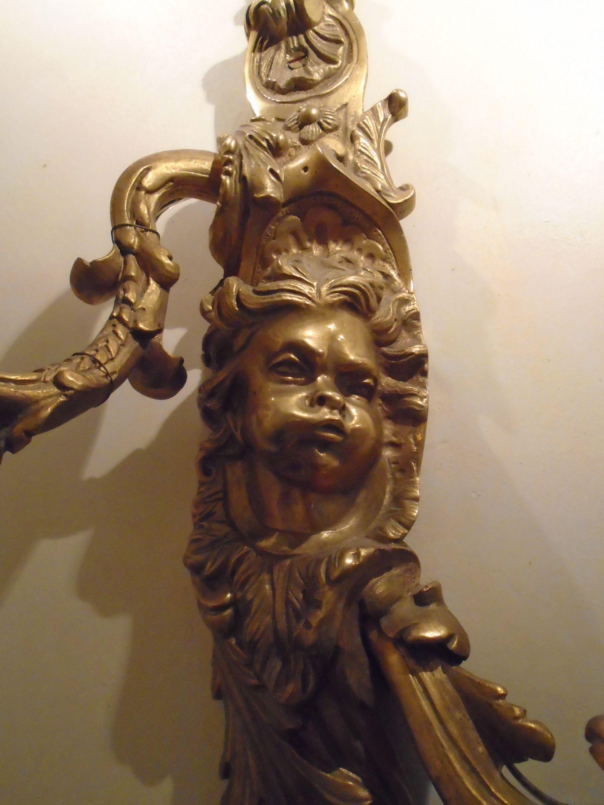 Pair of Bronze sconces with cherub face.