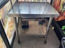 24" x 30" stainless steel table on casters with stainless steel legs and stainless steel under shelf