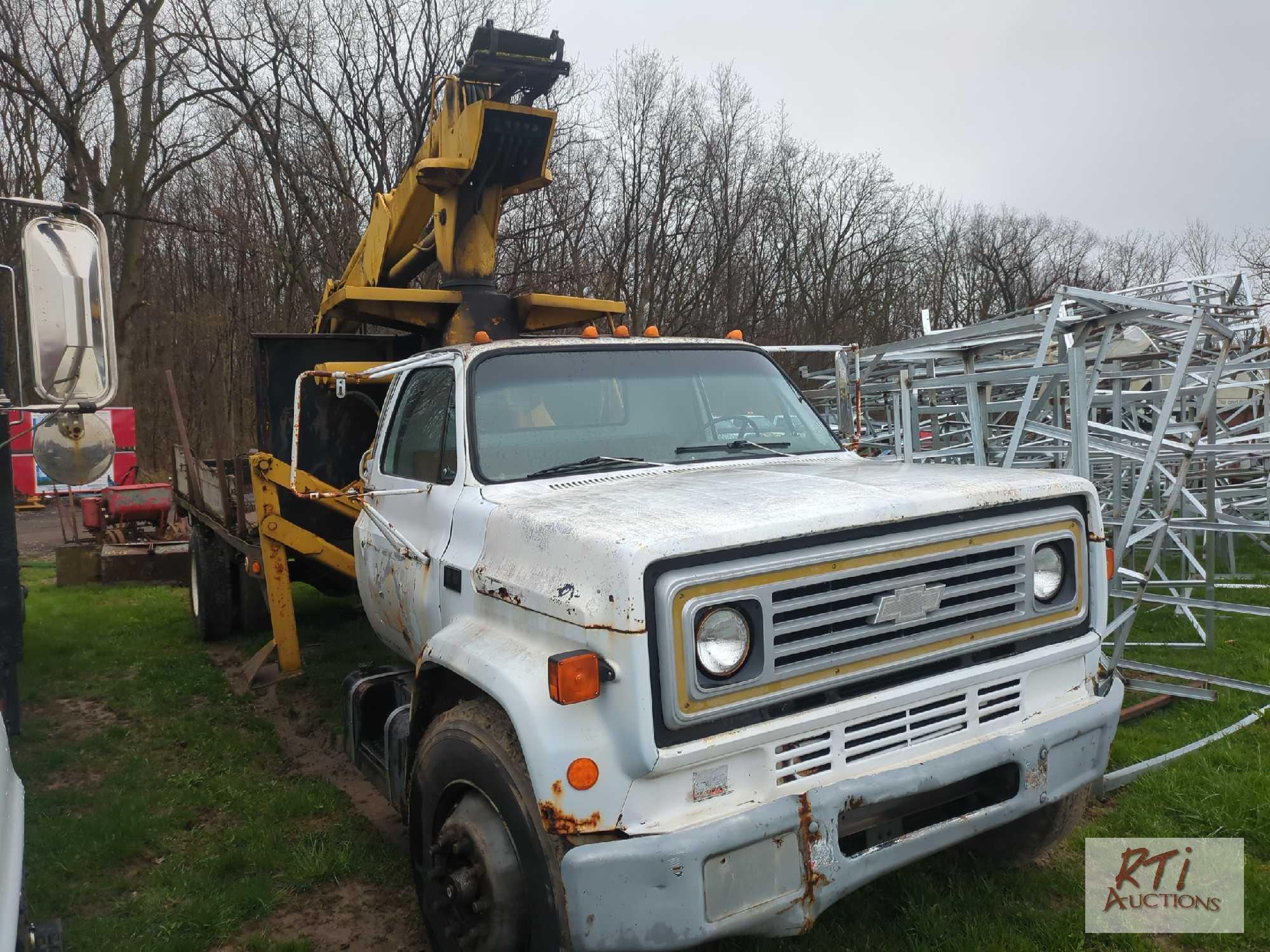 Chevy 7000 single axle flatbed grapple truck, with John Deere log grapple, outriggers, 5-speed