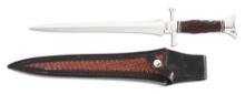 BUSTER WARENSKI FLUTED GRIP DAGGER WITH TOOLED LEATHER SCABBARD.