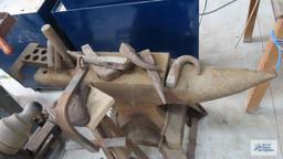 very heavy anvil mounted on stand with antique vise. comes with accessories and blacksmithing tools.