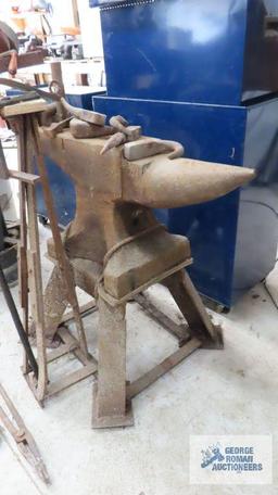 very heavy anvil mounted on stand with antique vise. comes with accessories and blacksmithing tools.