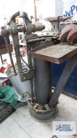 small anvil, pipe vise parts, hand grinder and antique vise mounted on heavy duty stand