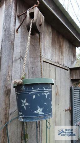 Hanging planter with antique pulley