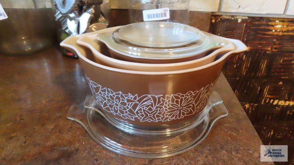 Pyrex three-piece brown casserole set with glass lids