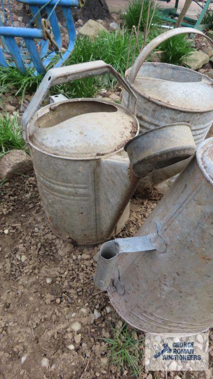 Three large galvanized watering cans