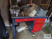 Metal painted desk with assorted items on top, including CD player, hardware, rope, wood burning