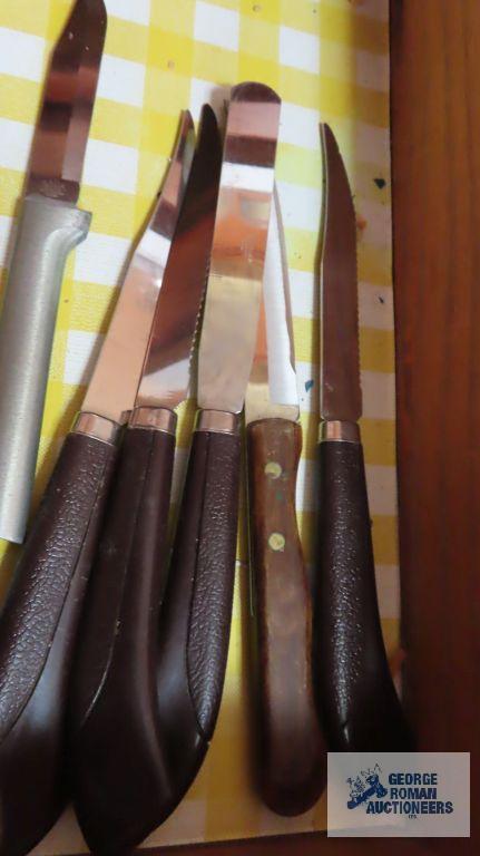 Assorted steak knives and other knives