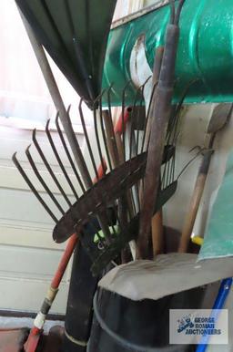 lot of yard and garden tools including spud bar, rakes, garden claw