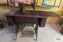 Singer antique throttle sewing machine in basement