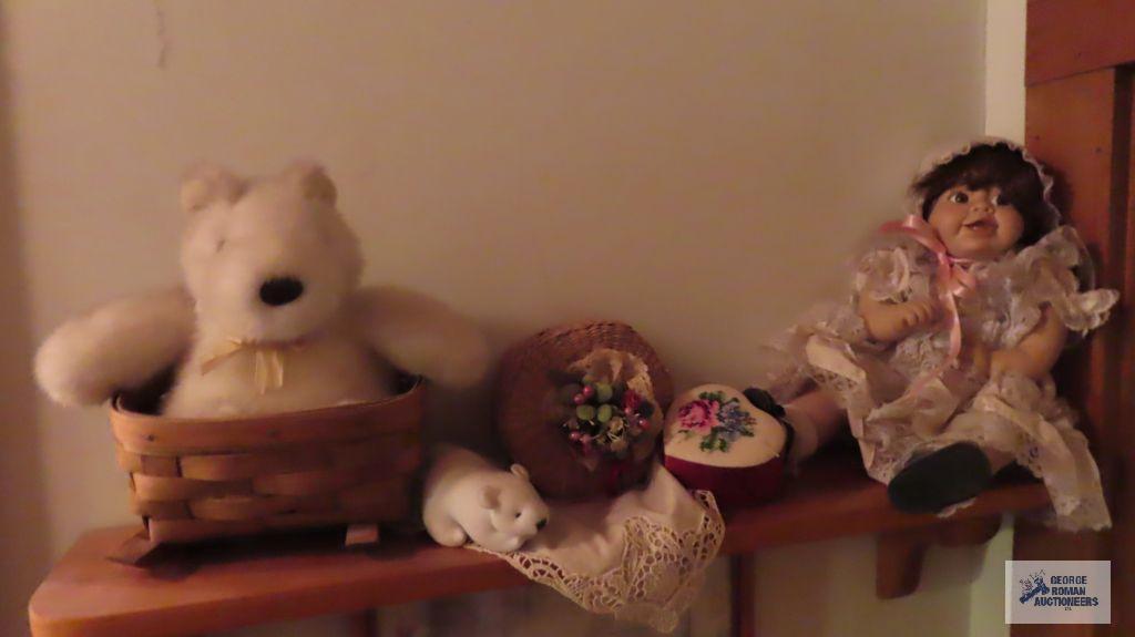 Shelf of assorted items. Baby doll, decorated boxes, teddy bear