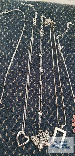 Silver colored costume jewelry necklaces