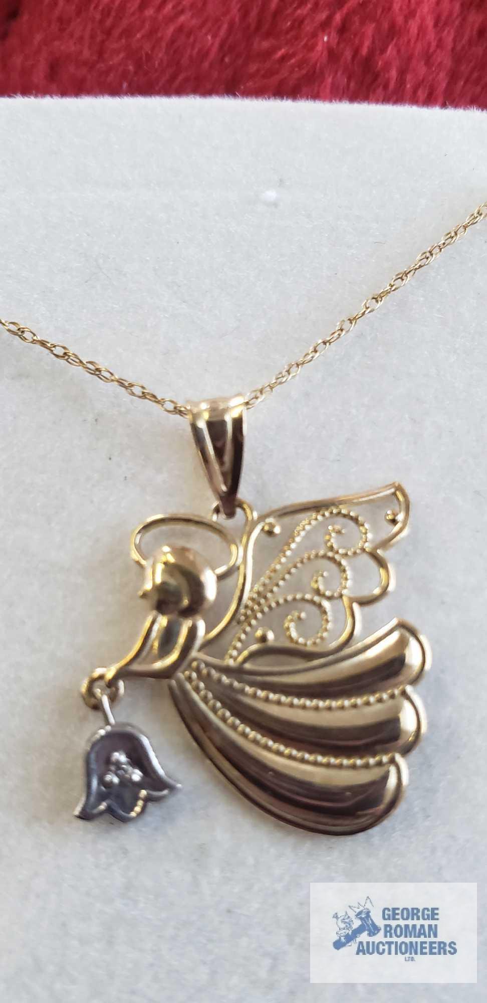 Two tone angel pendant, marked 10K, on gold colored necklace, marked 10K, total approximate weight