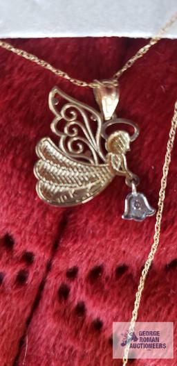Two tone angel pendant, marked 10K, on gold colored necklace, marked 10K, total approximate weight