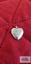 Silver colored heart-shaped locket, marked STER, approximately 2.82 G