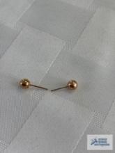 Two gold colored stud earrings, one marked 10K, one marked 14K, approximate total weight is .16 G