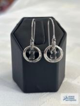 Silver colored dangle earrings with blue gemstone, marked 925