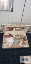 Floral mirrored jewelry box with assorted pins and earrings