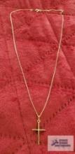 Gold colored cross with clear gemstone chip, marked 14K on gold colored necklace, marked 10K,
