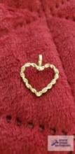 Gold colored heart-shaped pendant, marked 14K, approximate total weight....67 G
