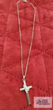 Silver colored cross with praying hands, marked Sterling on silver colored chain marked Sterling,