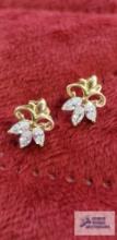 Pair of gold colored with three clear gemstone earrings, marked 10K, approximate total weight is