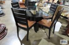 Glass top table and five chairs