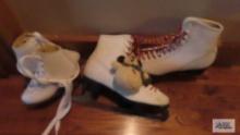 Pair of child and pair of adult white ice skates