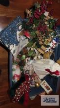 Tote of Christmas decorations, including runners and Angel and others