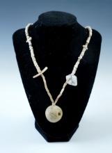24" strand of Drilled Shell Beads with a large stone or clay bead as a pendant. Oklahoma.