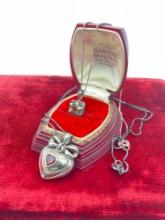 2x pair of sterling silver necklaces both with red glass stones - one locket - nice patina