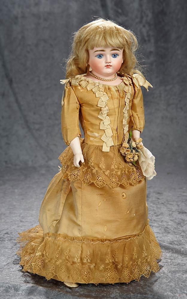 19" German bisque closed mouth doll by Kestner in lovely gold silk costume. $600/800