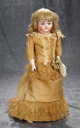 19" German bisque closed mouth doll by Kestner in lovely gold silk costume. $600/800
