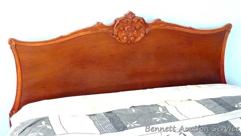 Antique bed headboard and footboard with scroll accents and claw feet. There are side boards but