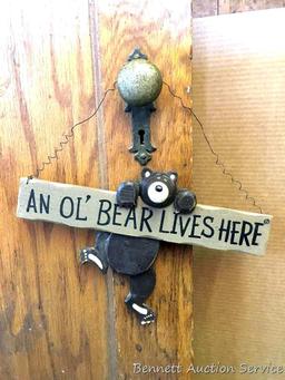Door Knob hanger: An Ol' Bear Lives Here, with free-swinging leg. 12" W x 12" overall height. Door