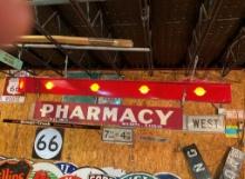 Pharmacy hanging from lighted arrow