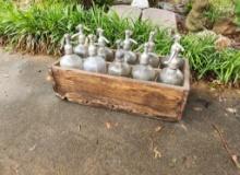 Set of antique soda fountain bottles with carrier