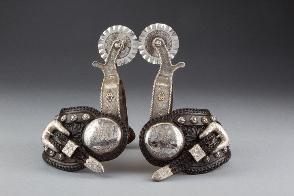 Outstanding pair of "Edward H. Bohlin, Hollywood, CA." marked, engraved silver overlay Spurs, full m